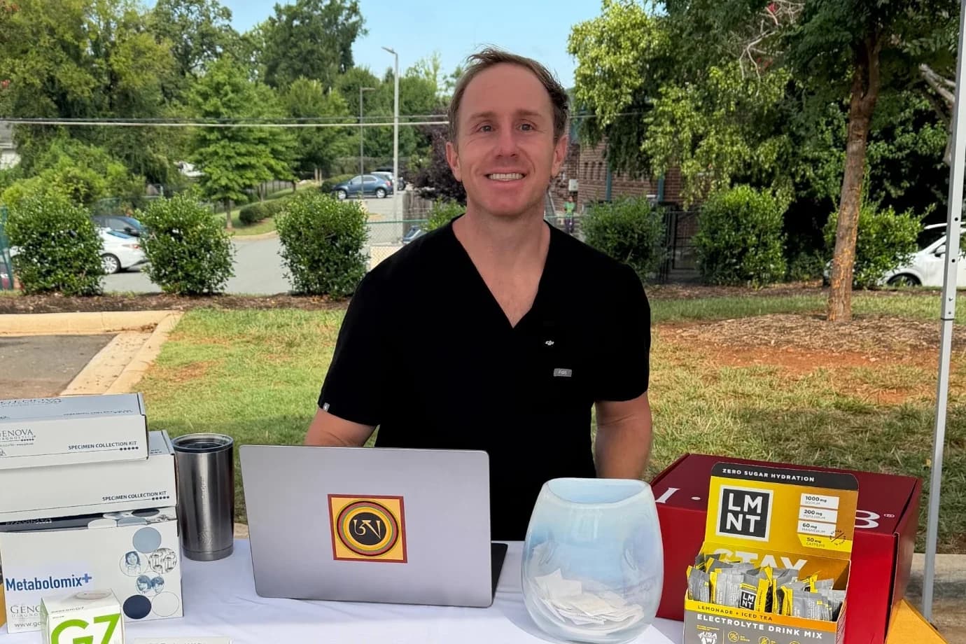 Dr. Daniel Tagge at a Tagge Health table at a community event in Charlotte