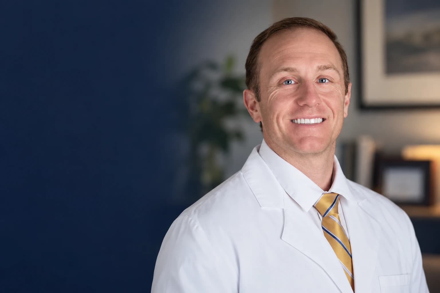 Dr. Daniel Tagge in a white coat in his office